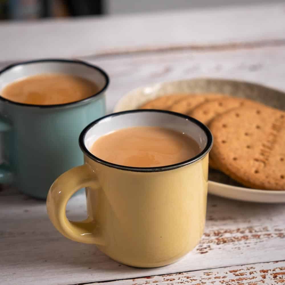 2 mugs of Tea and a plate of cookies