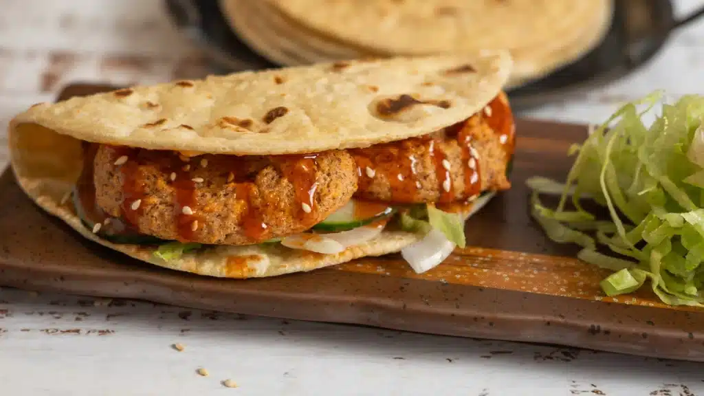 No Oil Brazilian Tapioca Crepe a Indian Roti with lentil Patty and lettuce on a wooden board