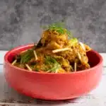 Sweet, Tangy & Juicy – Pineapple Chicken Recipe (Video) Pineapple chicken in a red bowl