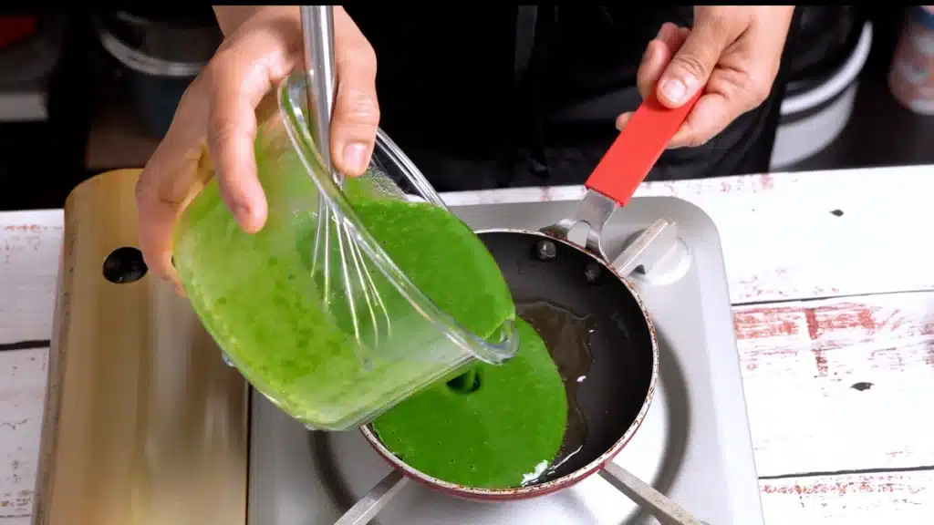 Green Omelette – Colorful, Nutritious, and Delicious pour egg in a pan to cook