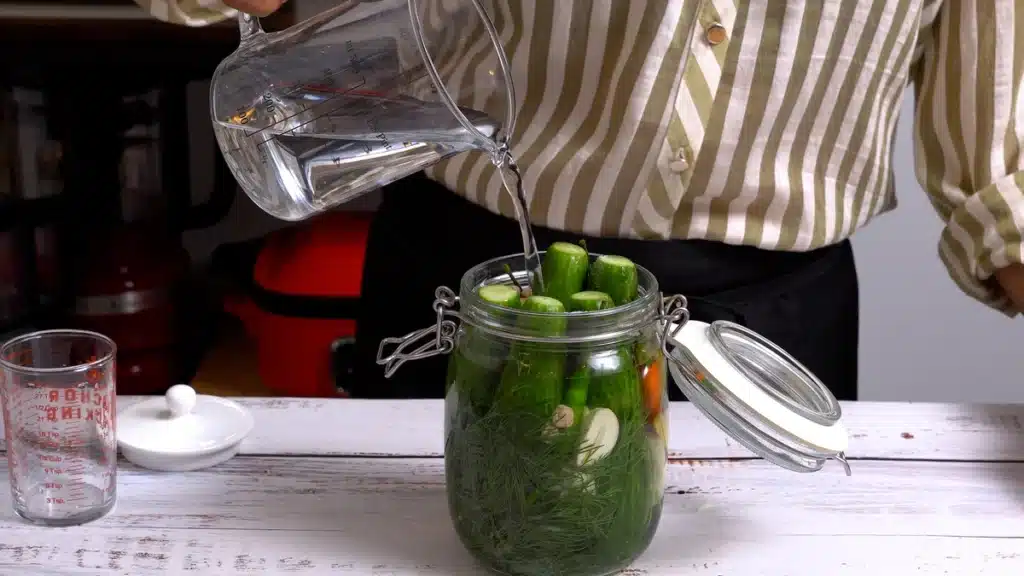 Quick Pickled Cucumber - Make Your Meals More Delicious add salt, vinegar and water in jar