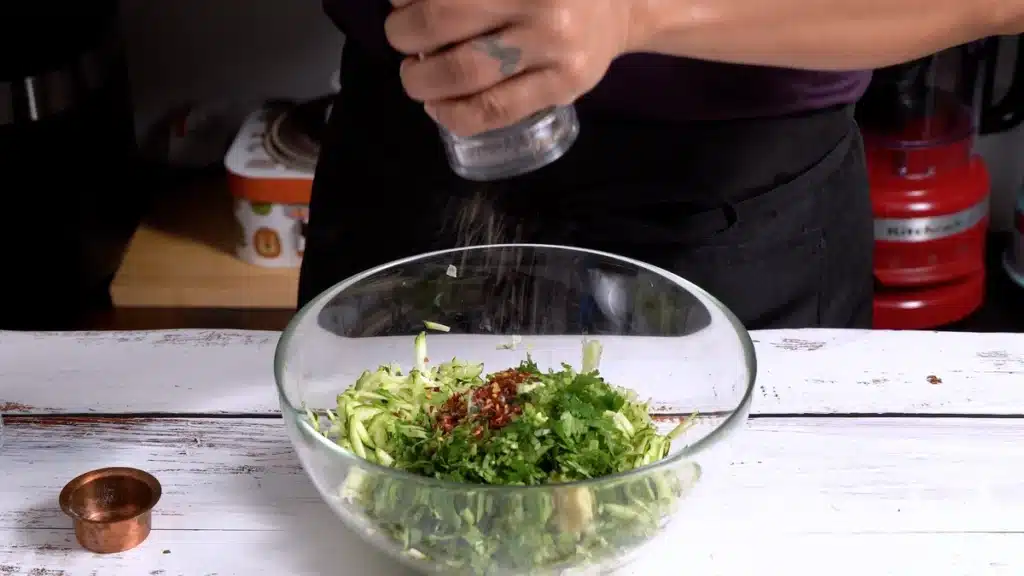 Easy No Dough Zucchini Paratha mix grated zucchini with chilli flakes and salt pepper