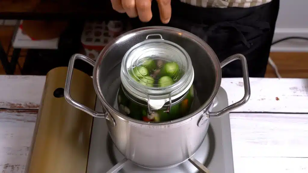 Quick Pickled Cucumber - Make Your Meals More Delicious place jar in boiling water