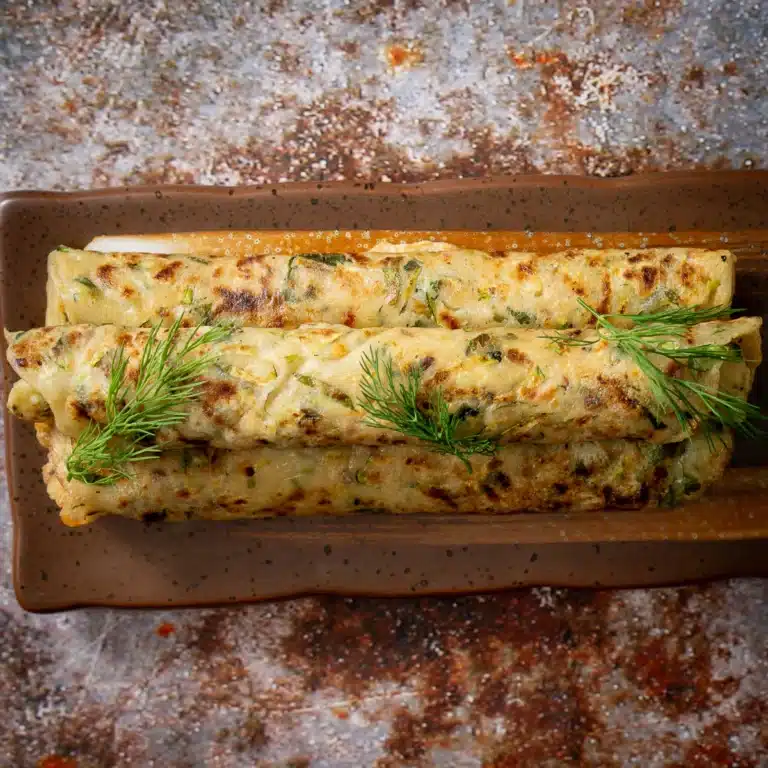 zucchini paratha rolled on a tray