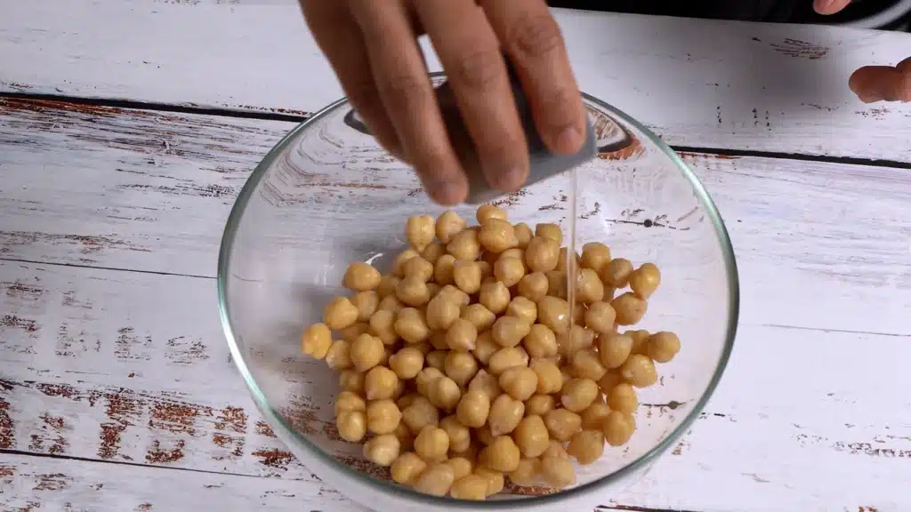 Crunchy Cinnamon Chickpeas - A Perfect Snacks add oil in chickpea and mix well