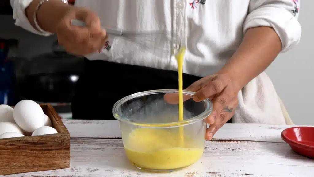 10-Minute Pizza Omelette – The Perfect Cheesy Breakfast beat egg with milk, salt and pepper