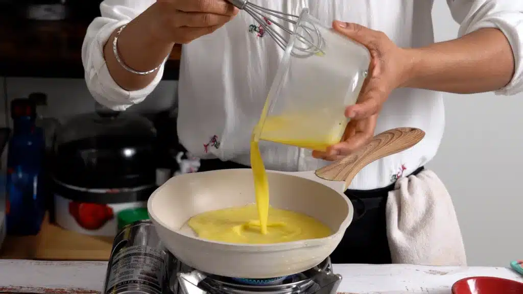 10-Minute Pizza Omelette – The Perfect Cheesy Breakfast on a hot pan pour egg mixture