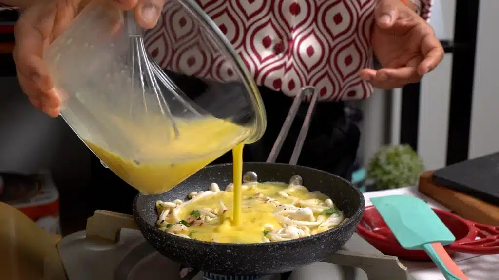 pour egg on mushrooms