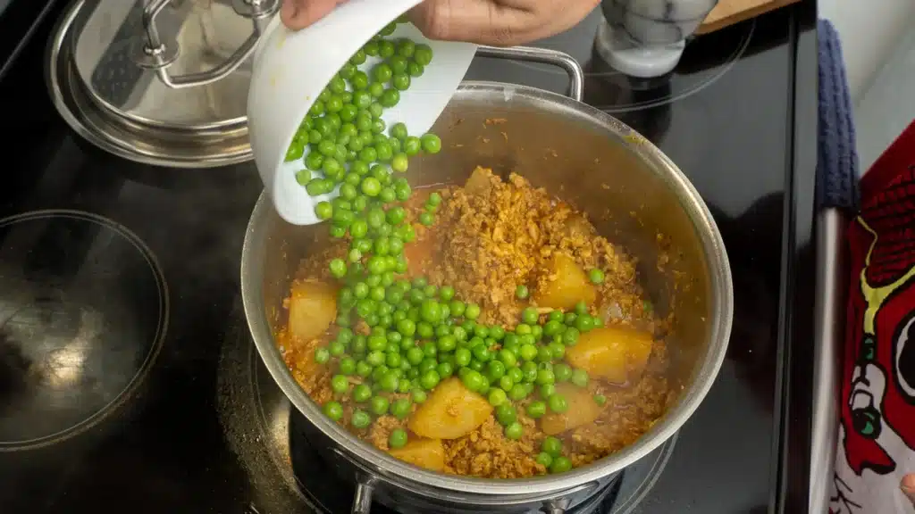 add potatoes and peas to the pan