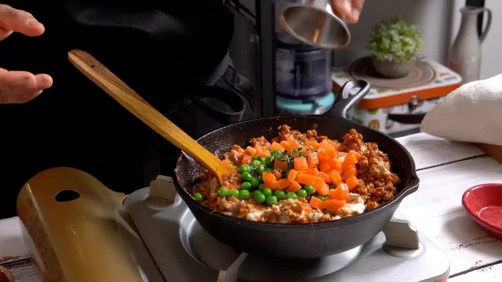 add tomato paste, yogurt, green peas, carrot and herbs