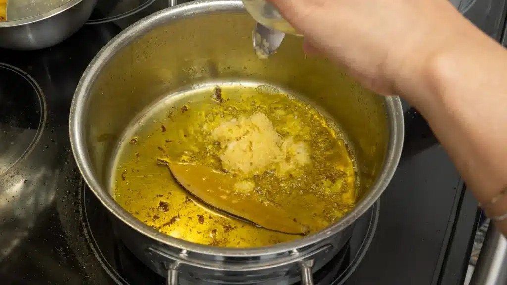 in same pot add bay leaf and ginger garlic paste