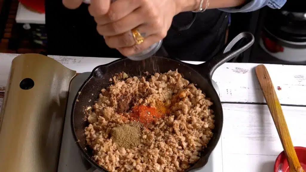 once chicken change color add all dry spices with salt, pepper and little hot water