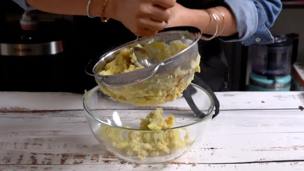 peel and mash a baked sweet potato using s strainer