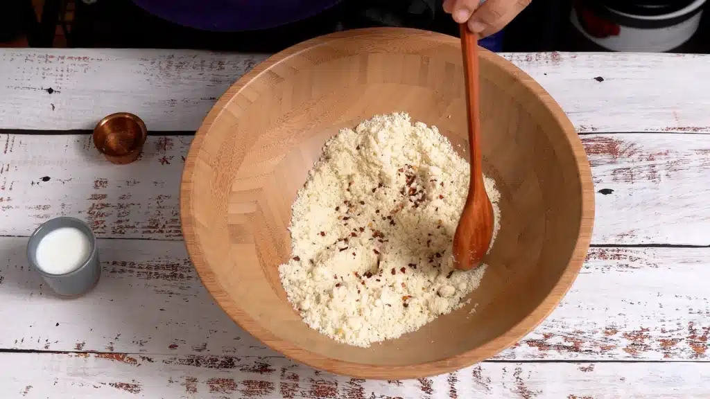 add almond flour with seasoning and chili flakes in a bowl
