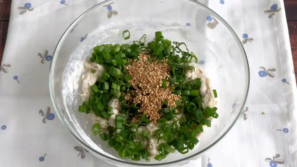 Green Onion Crackers (100% Better Than Store-Bought Snacks!) add dry ingredients with green onion and roasted sesame