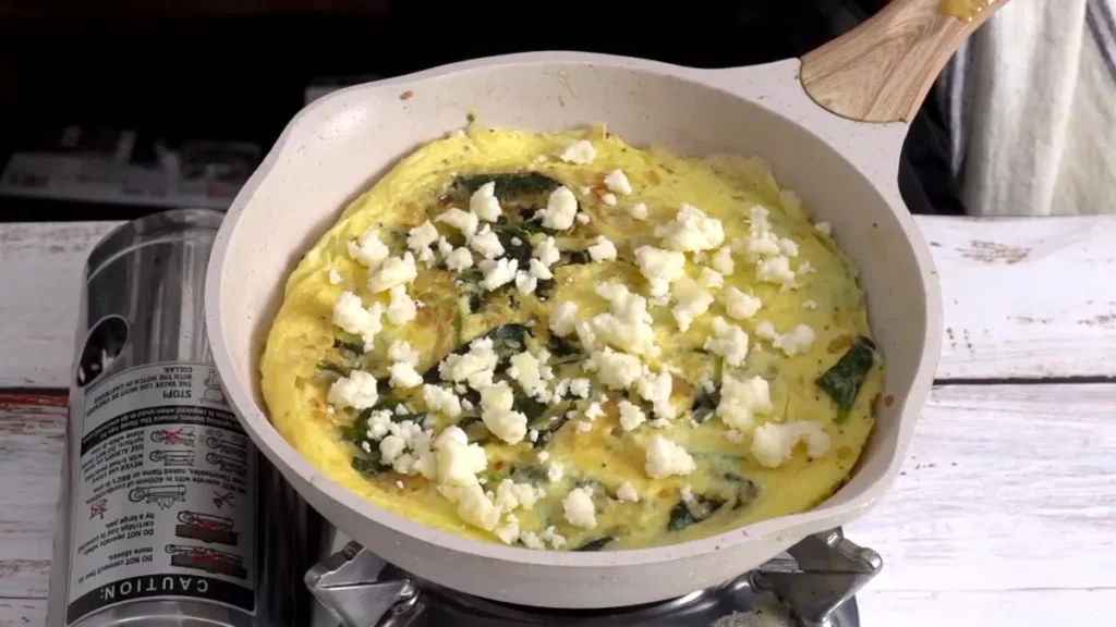Mediterranean Omelette: 15-Minute Easy Recipe flip and add crumbled feta