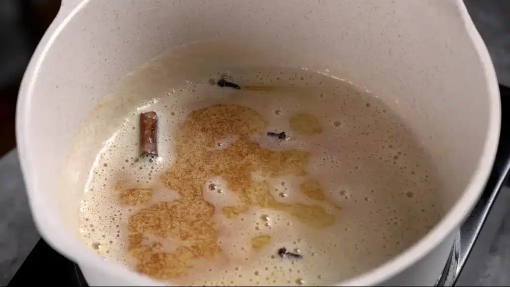 temper clove , cinnamon stick in butter