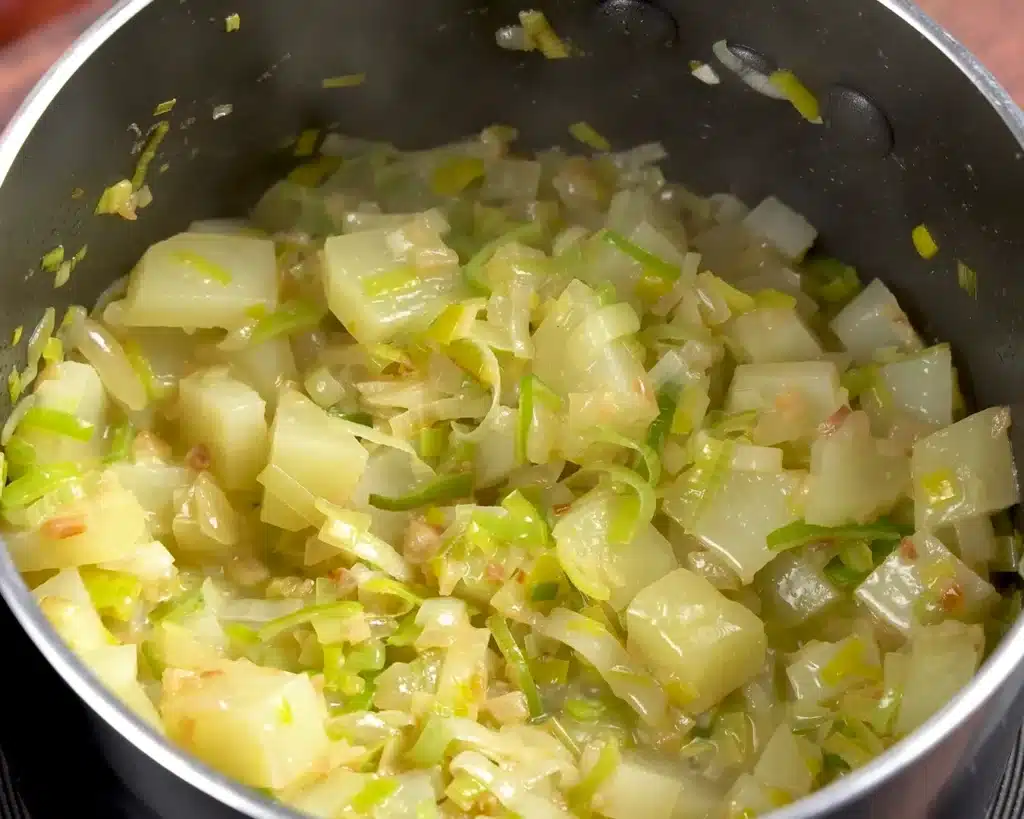 Leek and Garlic Soup Add the chopped onion, leek, butter, and potato, then cook everything until the potato softens.