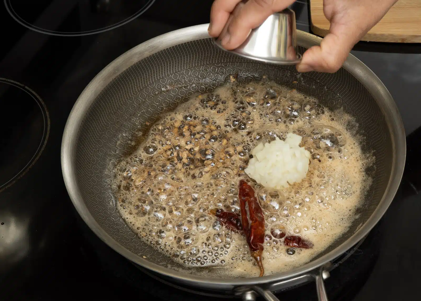 then add red chilli and garlic, in last onion