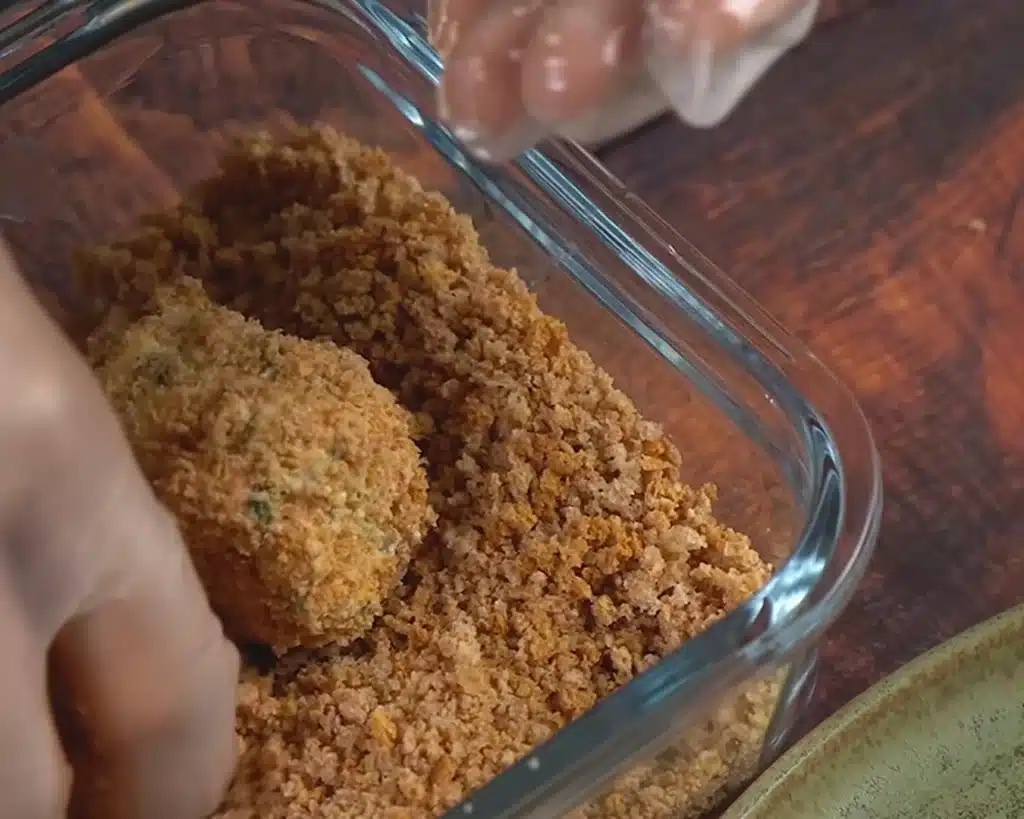 Roll each shaped piece softly through a shallow plate of crisp breadcrumbs