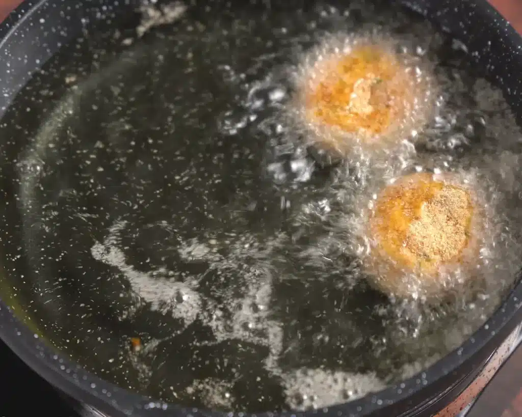 Fry the coated croquettes in warm oil until they turn a beautiful golden brown