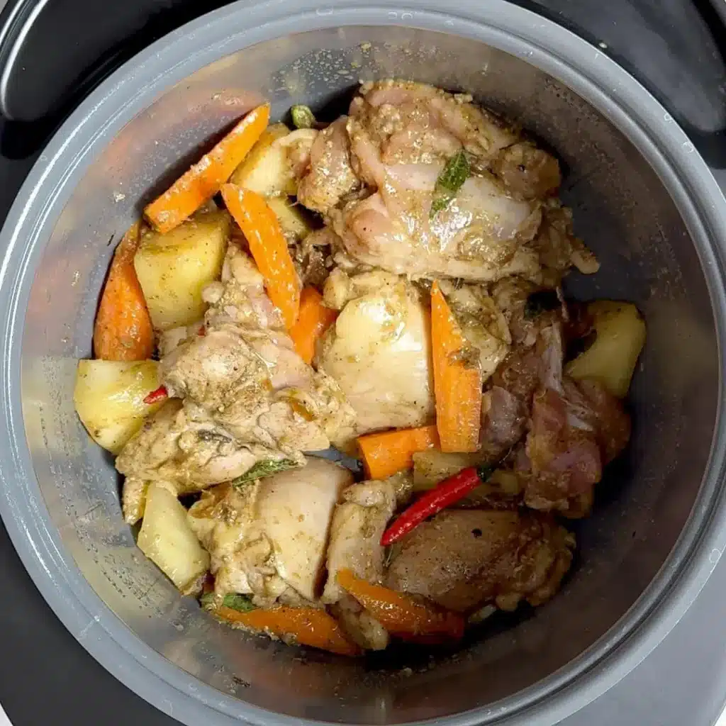 Slow Cooked Coconut Chicken Stew: Easy & Delicious Recipe add chicken with spices & mix