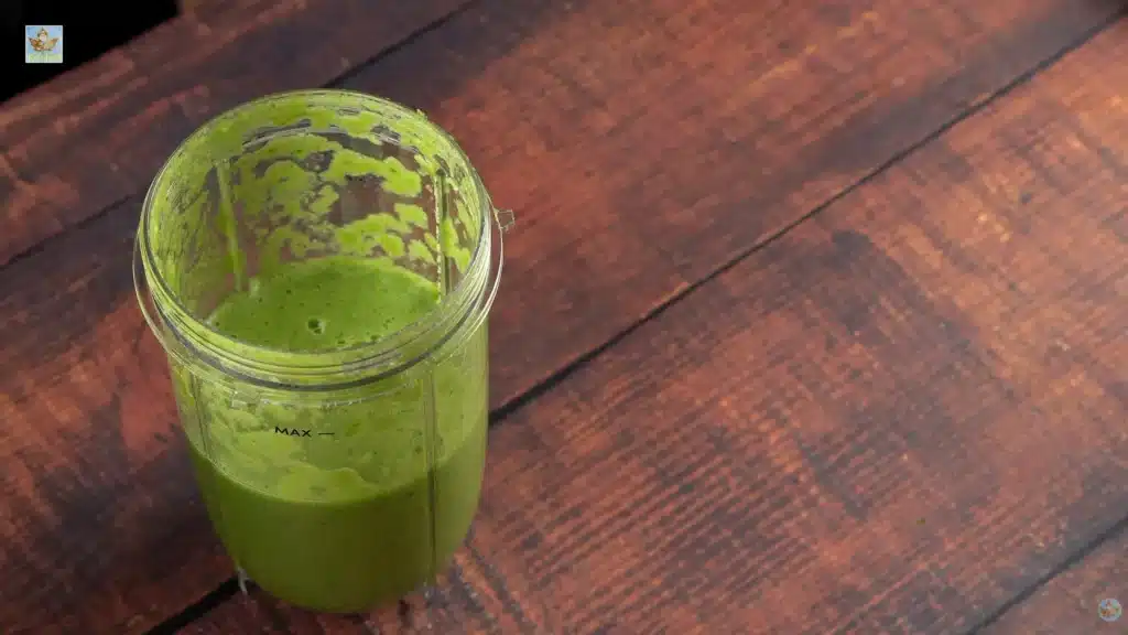 Toss your chopped coriander, garlic, ginger, onion, and jalapeño into a blender. Add the lime zest and 100ml of water. Blend everything until you create a smooth, bright green paste.