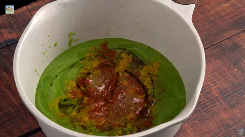 2 Pour the green paste into a pot on medium low heat