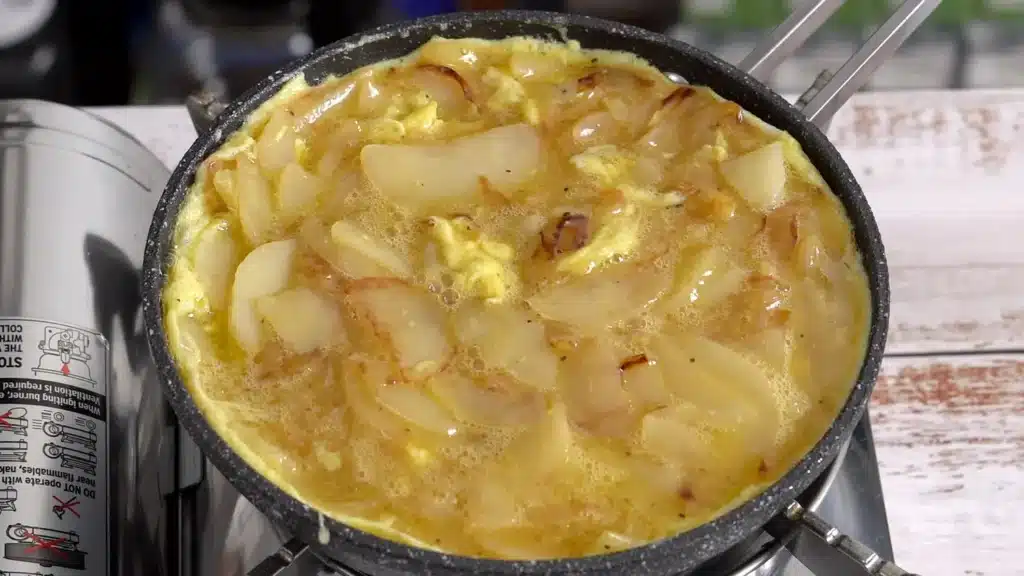 Fluffy, Golden & So Good – Spanish Omelette add mixture in pan , cover and cook
