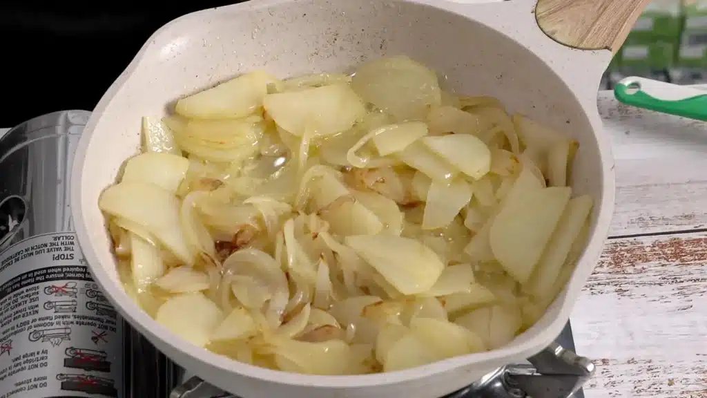 Fluffy, Golden & So Good – Spanish Omelette add onion, potato in pan and cook