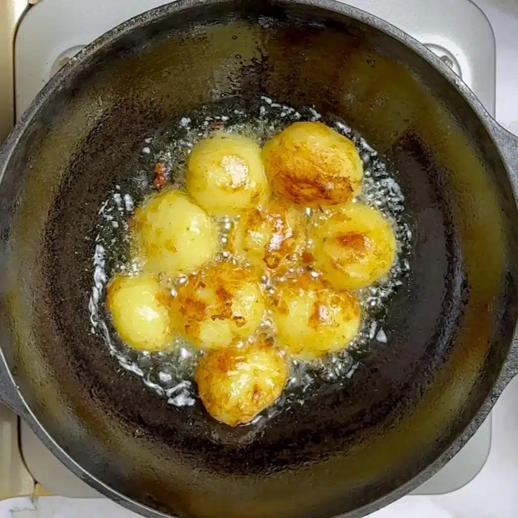 Kashmiri Dum Aloo Recipe: A Rich and Flavourful Indian Curry gently press potatoes , placed them in oil and fry