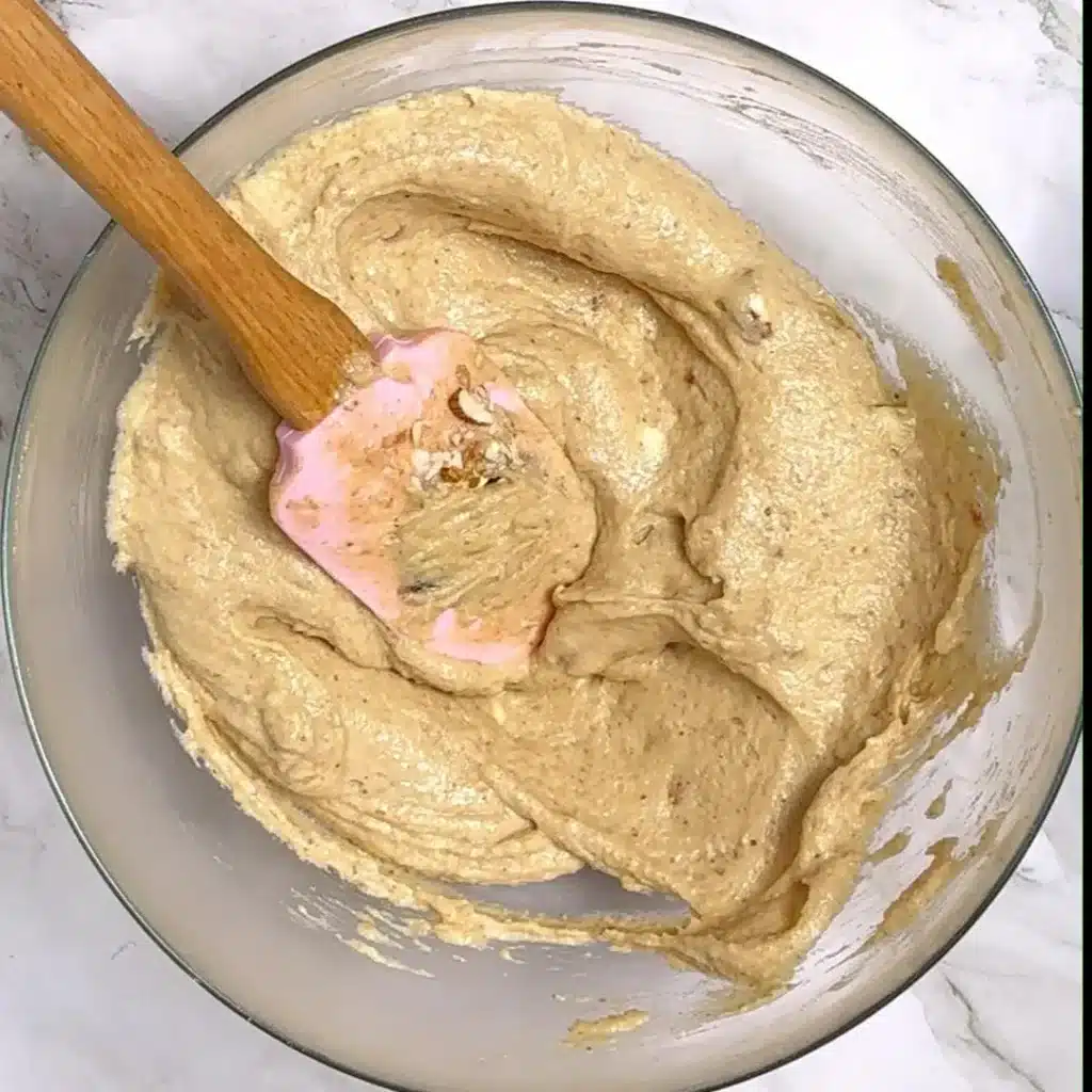 Simple Eggless Walnut Cake for Tea Time now add vinegar , chopped walnuts , final mix