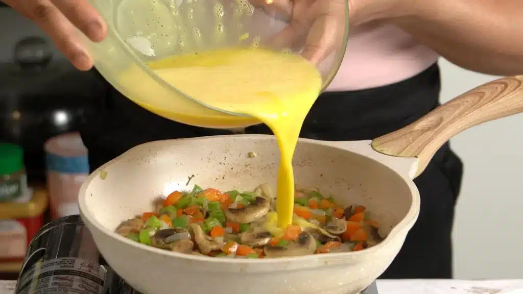 Breakfast Idea : Creamy Velveeta Omelette with veggies pour beaten eggs