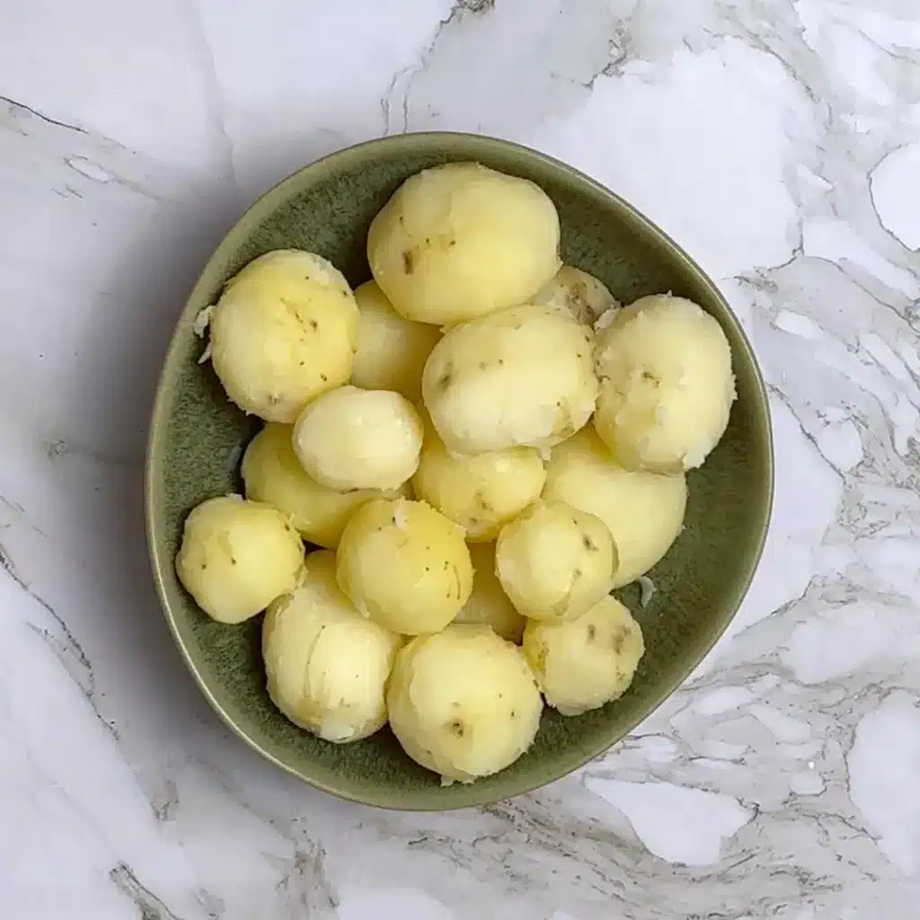 Kashmiri Dum Aloo Recipe: A Rich and Flavourful Indian Curry start by boiling potatoes