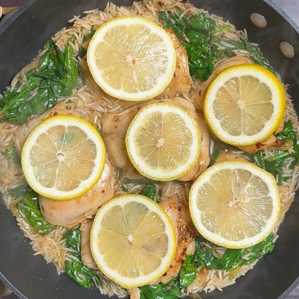 One Pan Spinach & Chicken Rice (Greek Inspired) add lemon slices on chicken , cover and cook