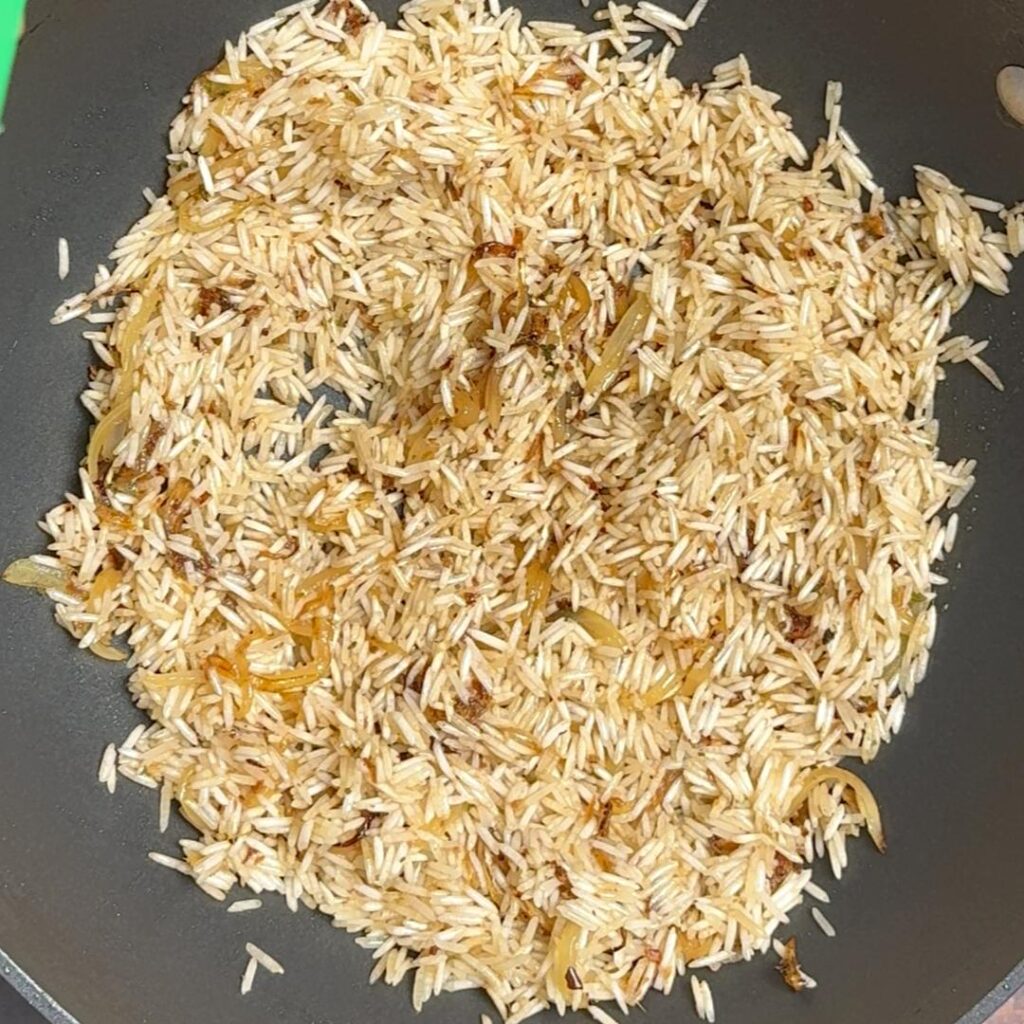 One Pan Spinach & Chicken Rice (Greek Inspired) now add sliced onion, then herbes , soaked rice , lemon juiice