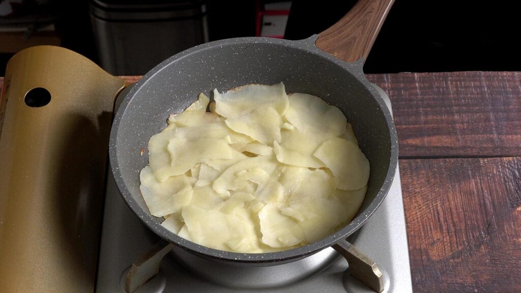 Easy Potato Omelette with Onions, Mushrooms and Cheese now heat a pan with oil or butter , add peeled potatoes