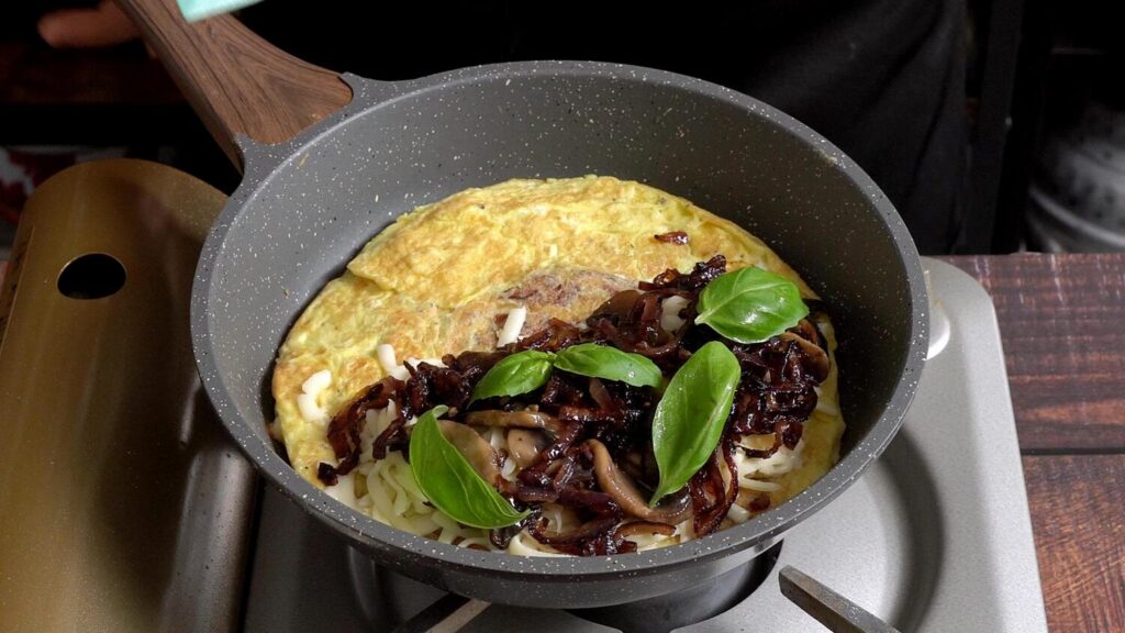 Easy Potato Omelette with Onions, Mushrooms and Cheese when both sides cooked, add caramilized onion, cheese,mushroom,basil leaves