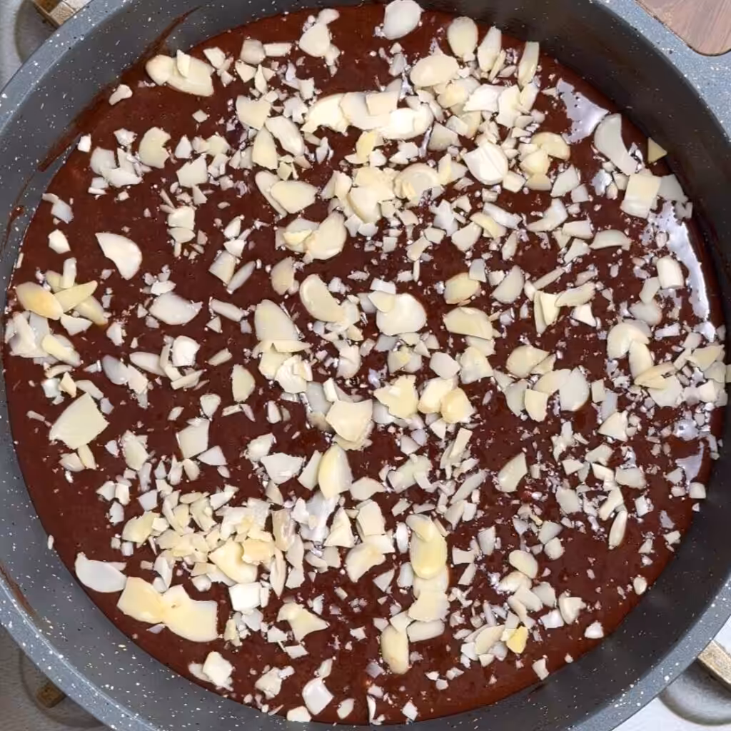 Now add the dry ingredients and mix well, Finally add sliced almonds