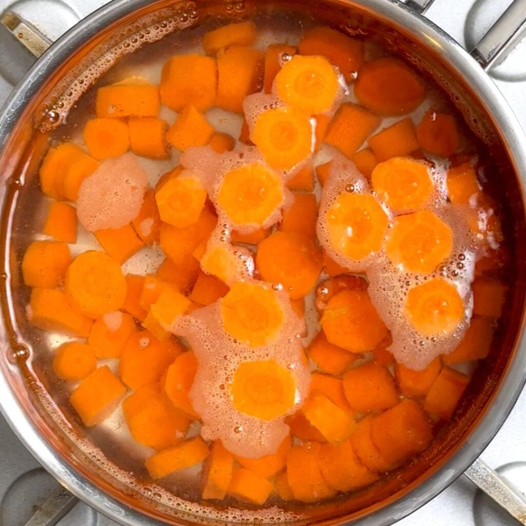start by peeling, cutting and boiling carrots 2