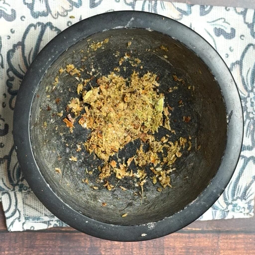 Caramel Tea With Whole Spices & Saffron In a mortar and pestle, add all the whole spices and crush them
